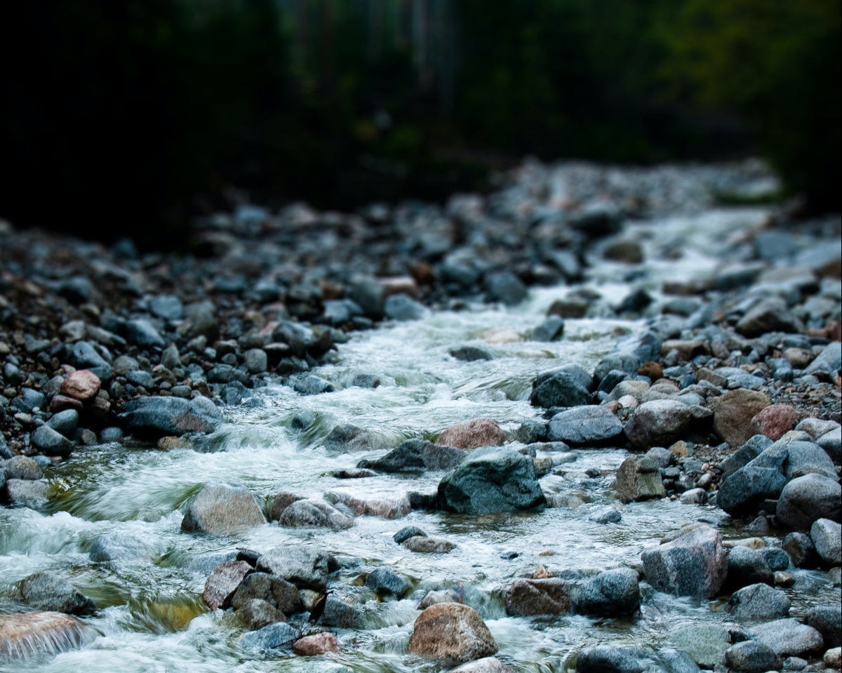 Stream flowing over rocks with a blurred background