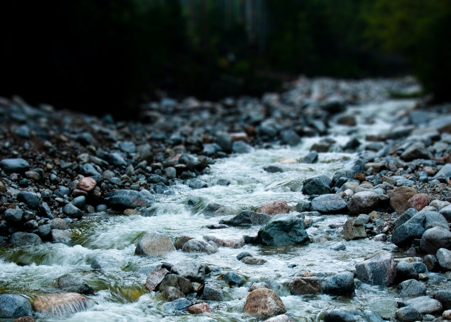 Stream flowing over rocks with a blurred background